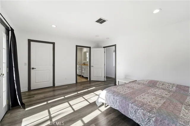 a bedroom with a bed and a mirror