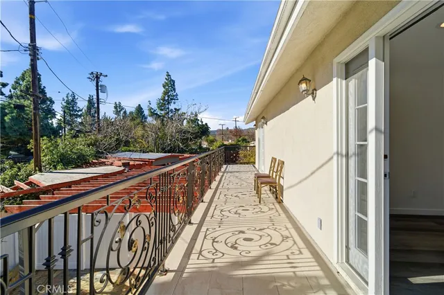 a view of a balcony with wooden floor and stairs