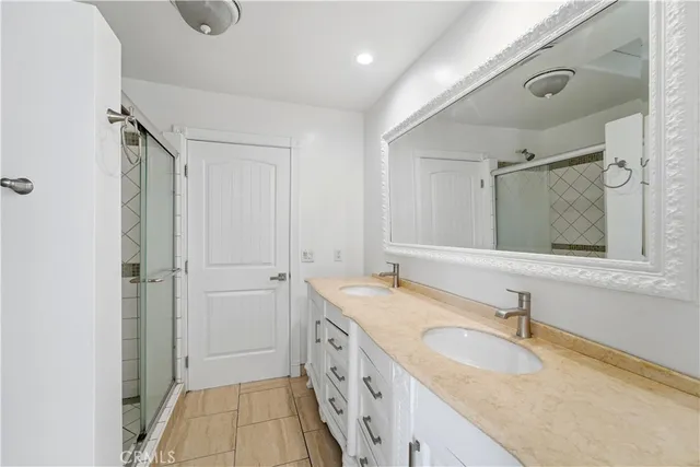 a bathroom with a granite countertop sink mirror and double