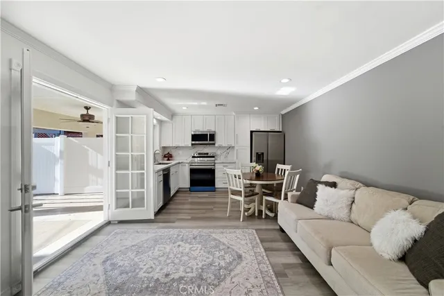 a living room with furniture and kitchen view
