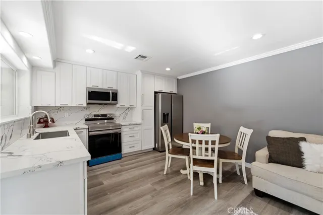 a view of a kitchen with a dining table and chairs