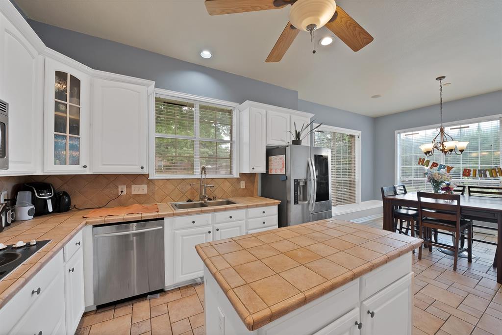 1912 Timber Ridge Court Cedar Hill, TX 75104 - Photo 13 of 35 Kitchen featuring white cabinetry, tile countertops, stainless steel appliances, a ceiling fan, and recessed lighting