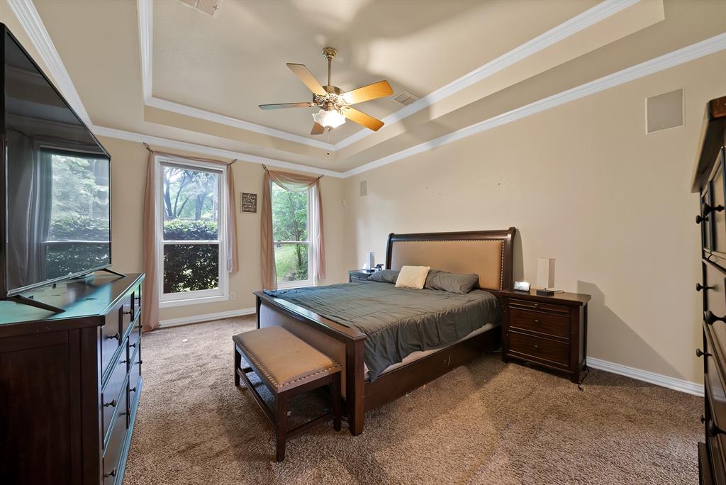 1912 Timber Ridge Court Cedar Hill, TX 75104 - Photo 14 of 35 Recessed tray ceiling with crown molding, ceiling fan with integrated lighting, and dual double-hung windows
