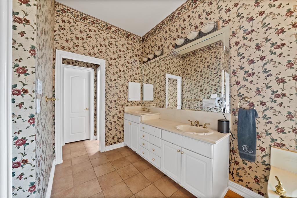 1912 Timber Ridge Court Cedar Hill, TX 75104 - Photo 17 of 35 Spacious vanity featuring dual sinks, white cabinetry, and an expansive wall-mounted mirror