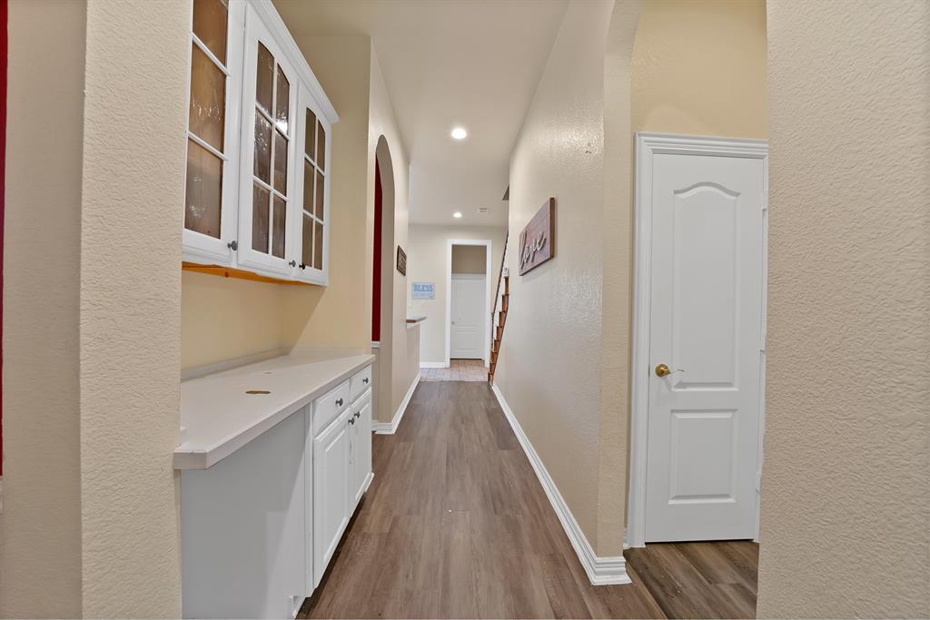1912 Timber Ridge Court Cedar Hill, TX 75104 - Photo 18 of 35 Hallway featuring wood-finish flooring and light-toned walls