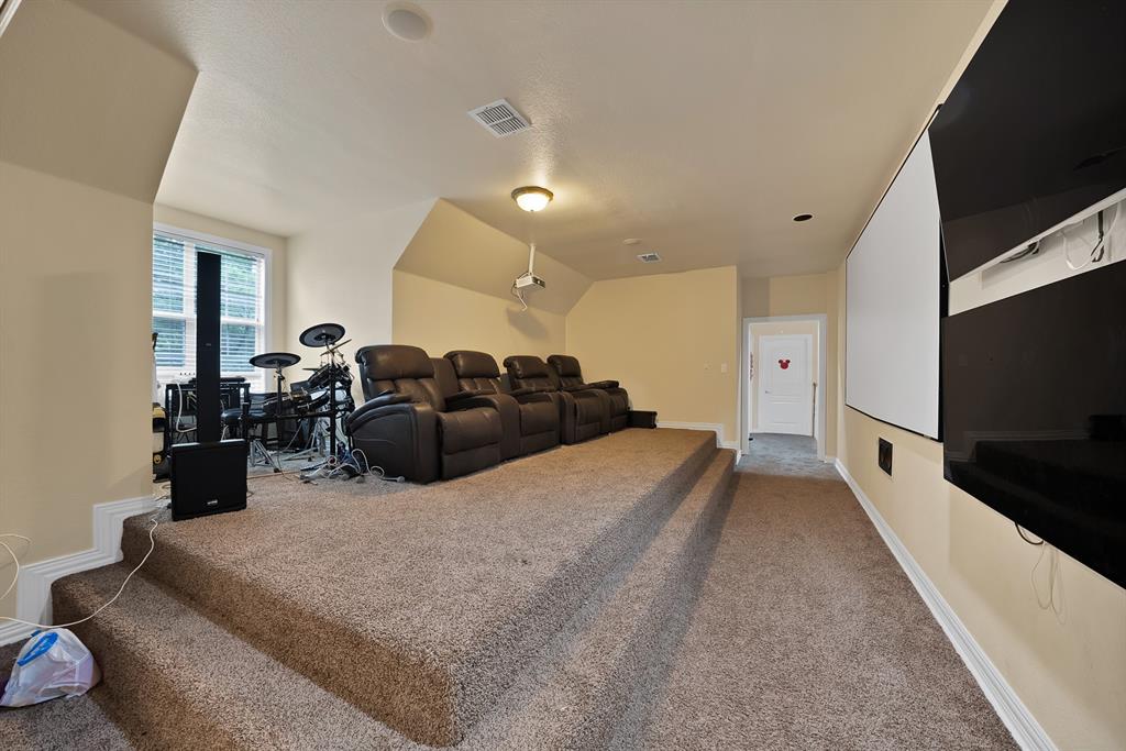 1912 Timber Ridge Court Cedar Hill, TX 75104 - Photo 23 of 35 Dedicated entertainment space featuring tiered carpeted flooring