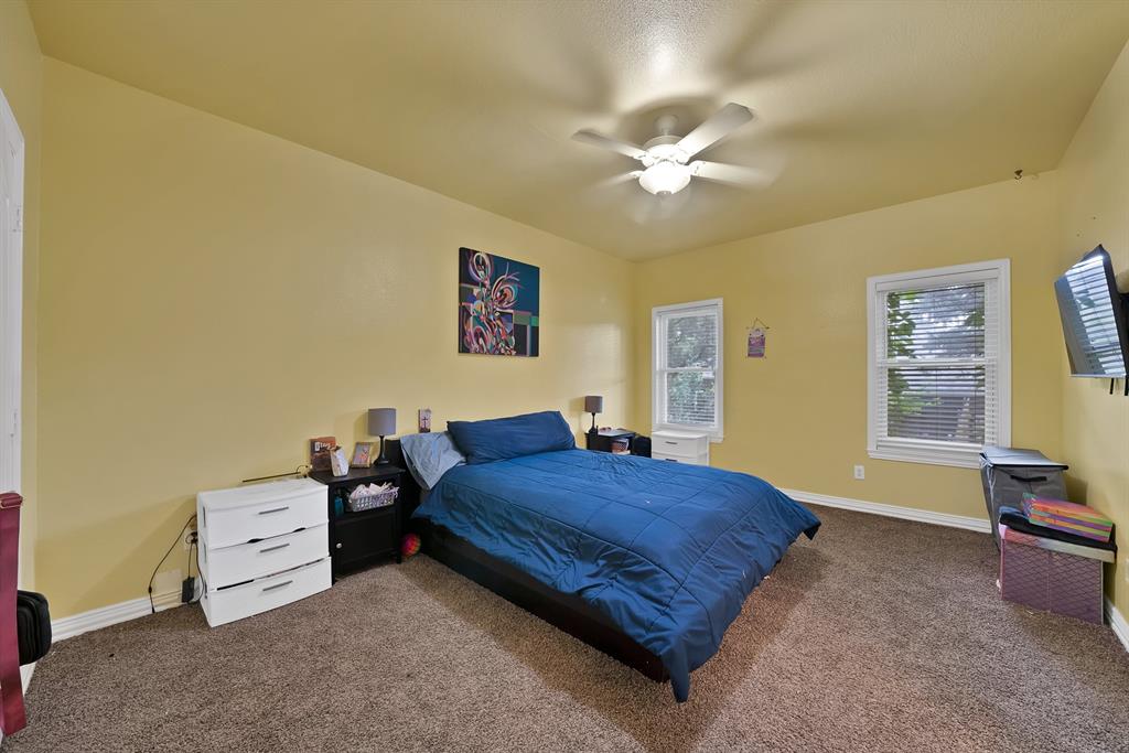 1912 Timber Ridge Court Cedar Hill, TX 75104 - Photo 24 of 35 Spacious room featuring carpeting, two windows with blinds, and a ceiling fan with integrated lighting