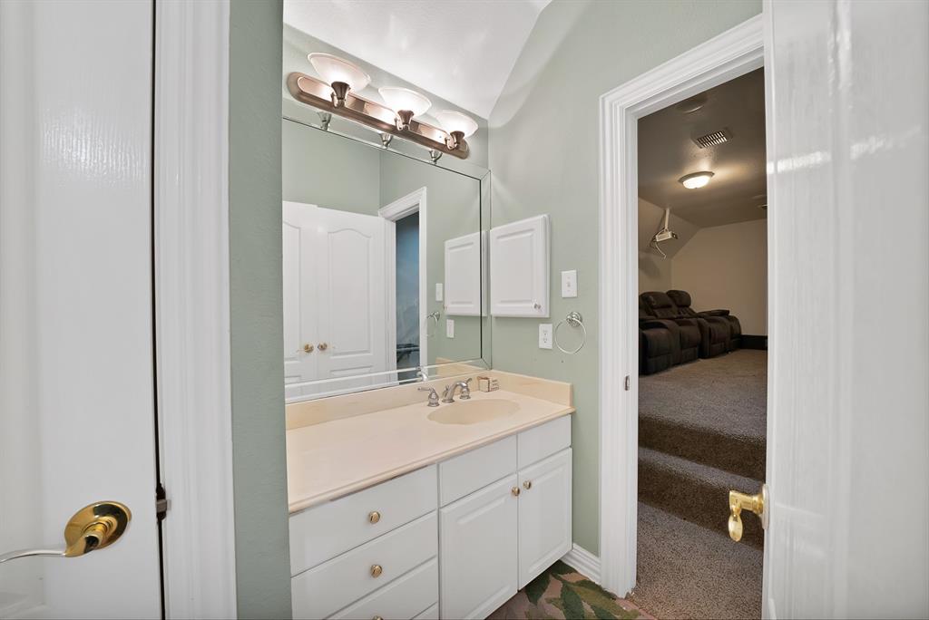 1912 Timber Ridge Court Cedar Hill, TX 75104 - Photo 25 of 35 Bathroom vanity with a single basin sink, light-toned countertop, and white cabinetry