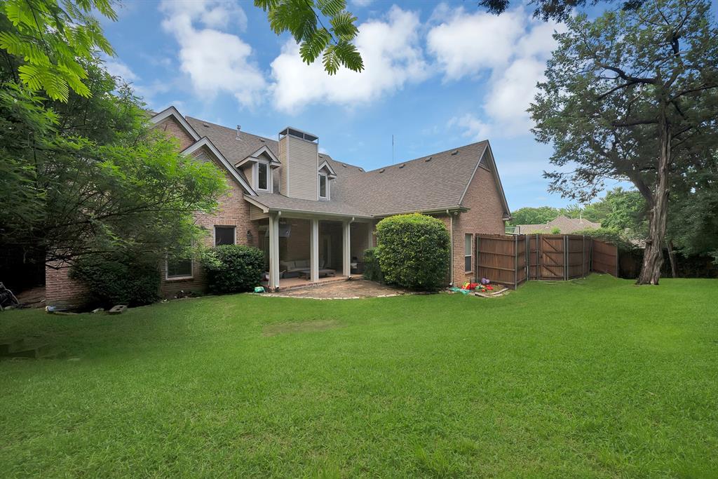 1912 Timber Ridge Court Cedar Hill, TX 75104 - Photo 28 of 35 Expansive green lawn with mature trees bordering a brick residence