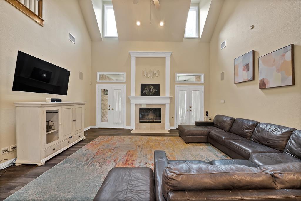 1912 Timber Ridge Court Cedar Hill, TX 75104 - Photo 10 of 35 Soaring vaulted ceiling featuring a ceiling fan and upper windows