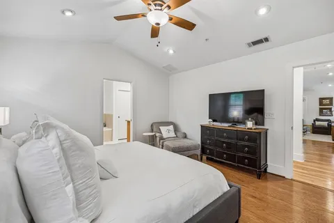 a bedroom with a bed and a flat screen tv
