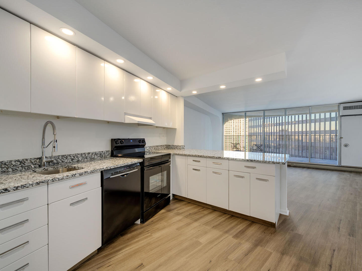 300 North State Street, Unit 3330 Chicago, IL 60654 - Photo 8 of 20 a kitchen with granite countertop a stove top oven sink and cabinets