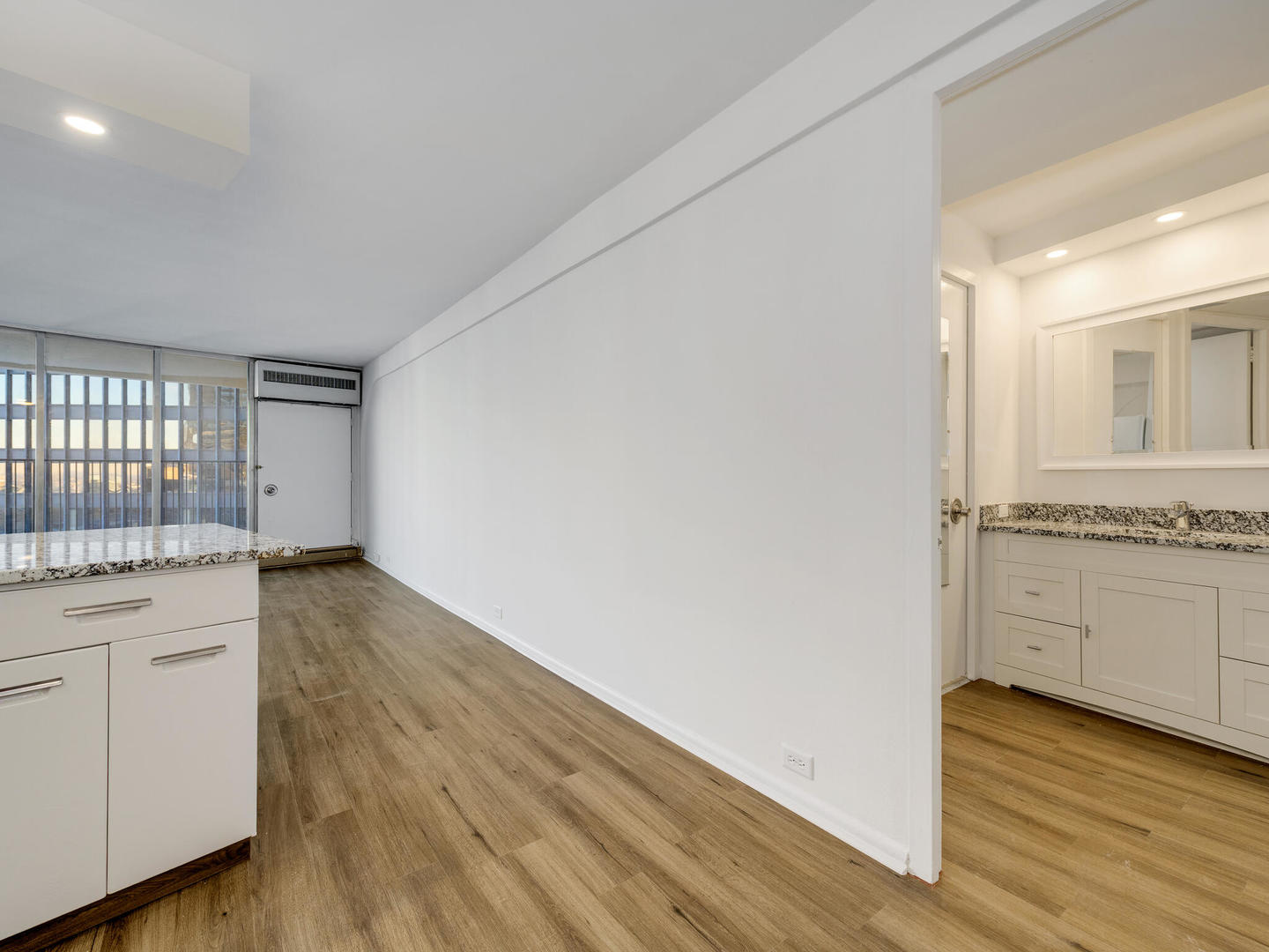 300 North State Street, Unit 3330 Chicago, IL 60654 - Photo 9 of 20 a view of a kitchen with a sink and dishwasher with wooden floor