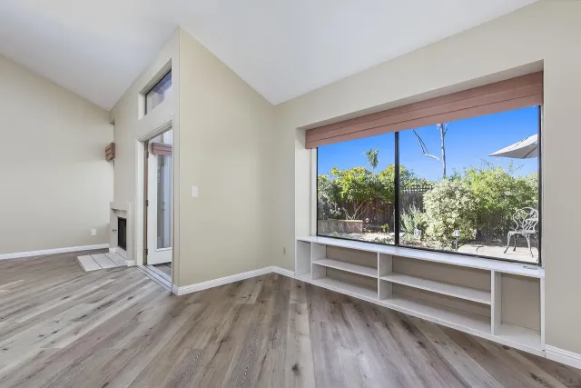 wooden floor in an empty room with a window