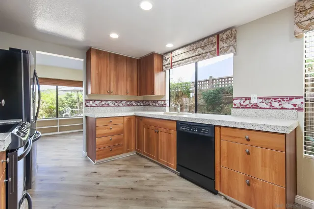 a kitchen with stainless steel appliances granite countertop a stove a sink and a refrigerator