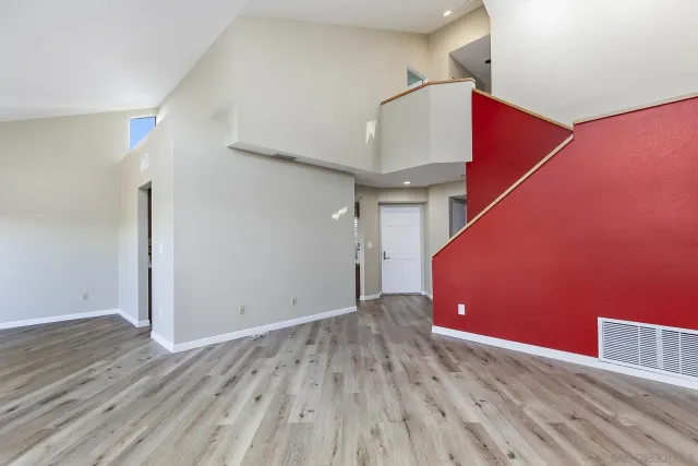 a view of a room with wooden floor and staircase