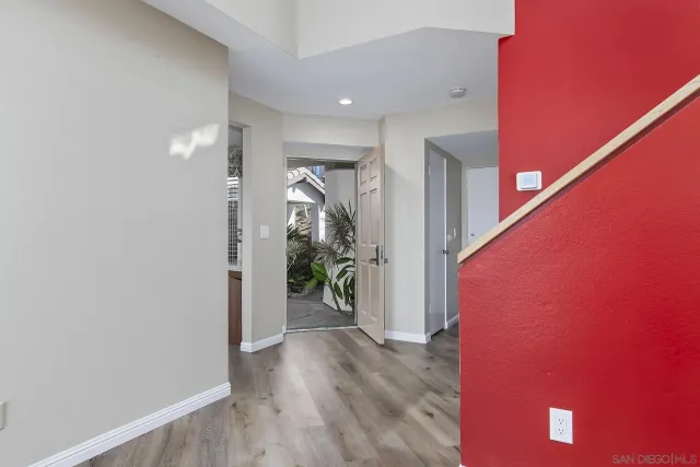 a view of hallway with wooden floor