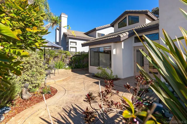 an aerial view of residential houses with outdoor space and parking