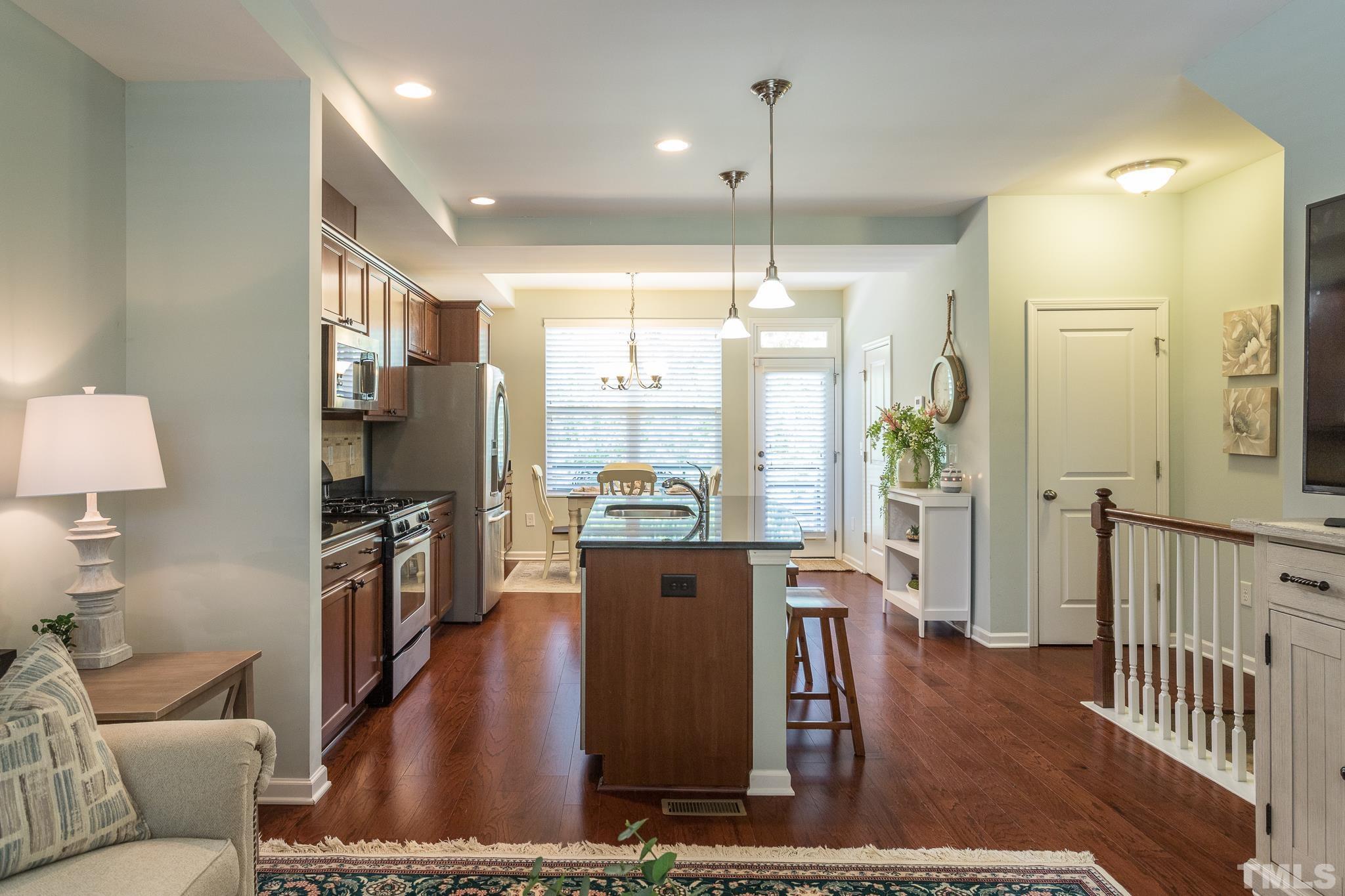 1621 Crafton Way Raleigh, NC 27607 - Photo 11 of 30 a living room with furniture a large window and wooden floor