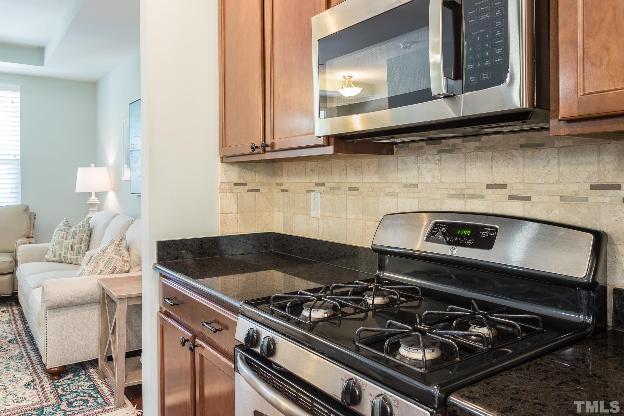 1621 Crafton Way Raleigh, NC 27607 - Photo 14 of 30 a kitchen with a stove and a microwave