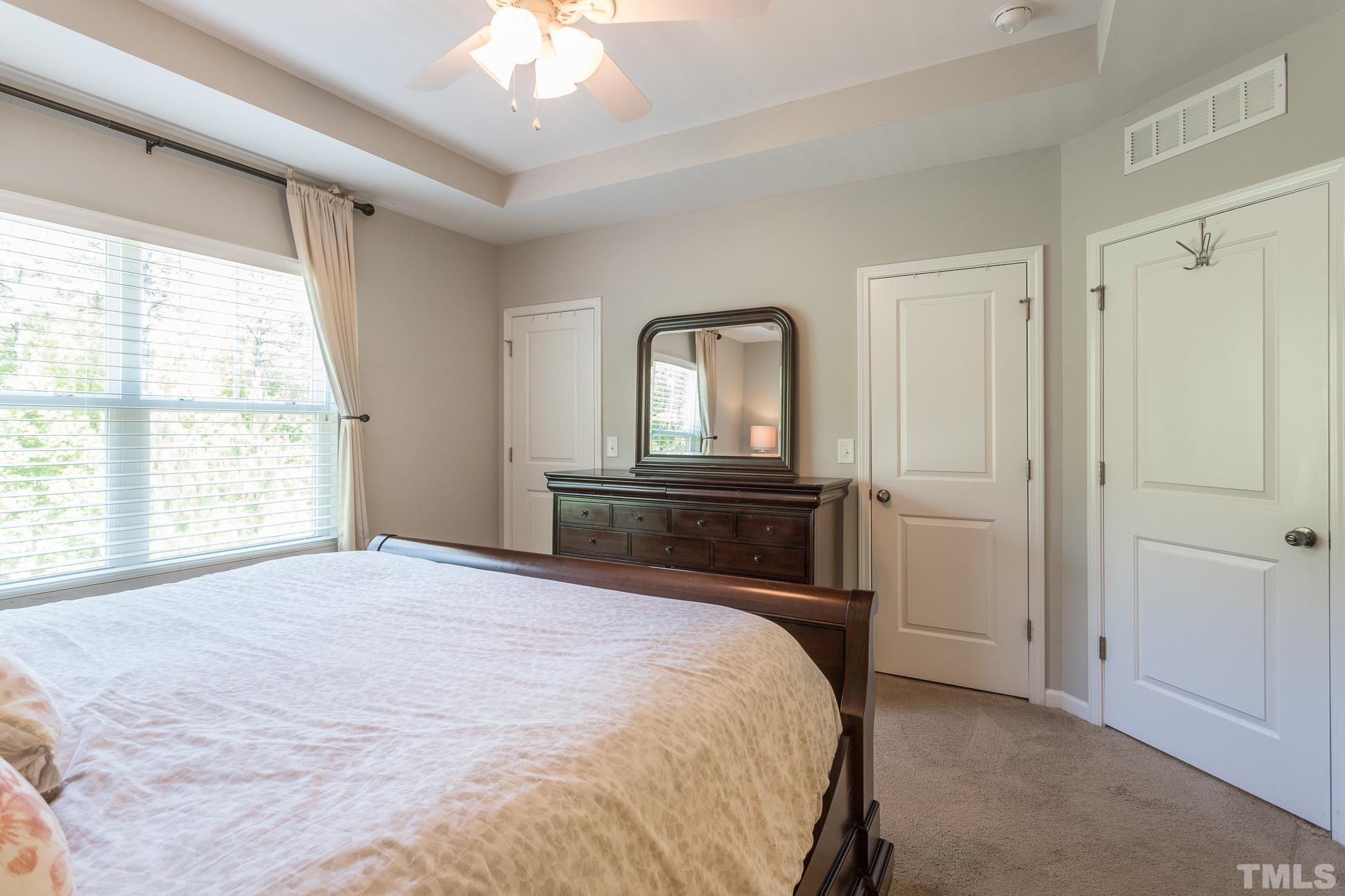 1621 Crafton Way Raleigh, NC 27607 - Photo 21 of 30 a bedroom with a bed and a chandelier