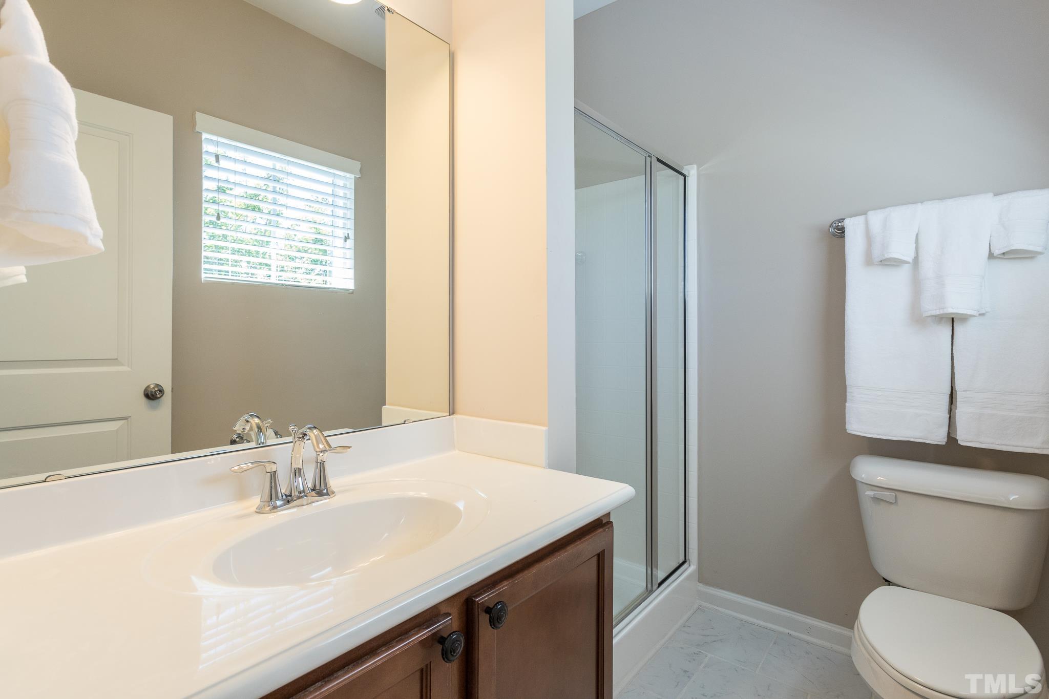 1621 Crafton Way Raleigh, NC 27607 - Photo 27 of 30 a bathroom with a sink a toilet and a mirror