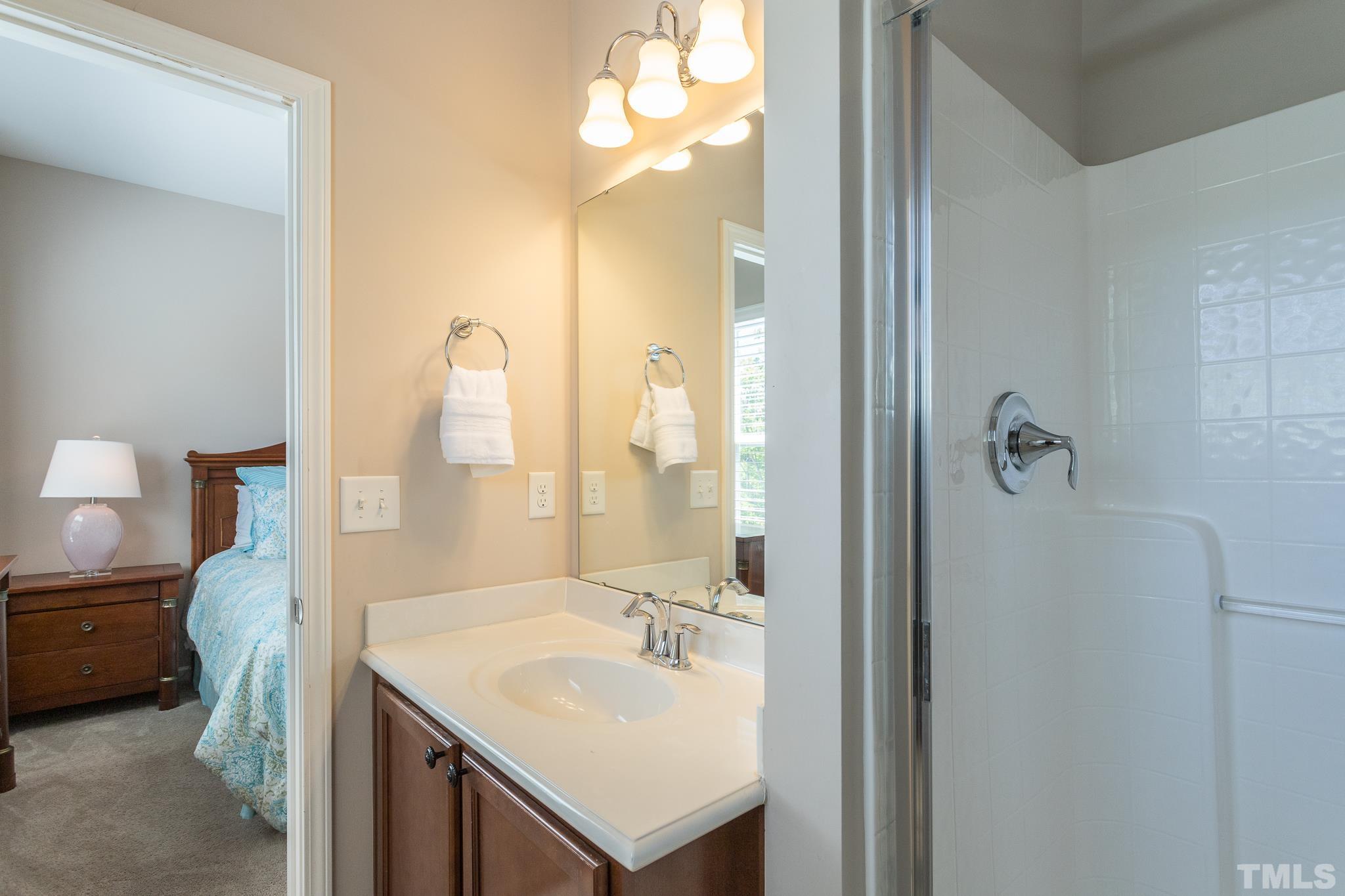 1621 Crafton Way Raleigh, NC 27607 - Photo 28 of 30 a bathroom with a sink a light fixture and a mirror