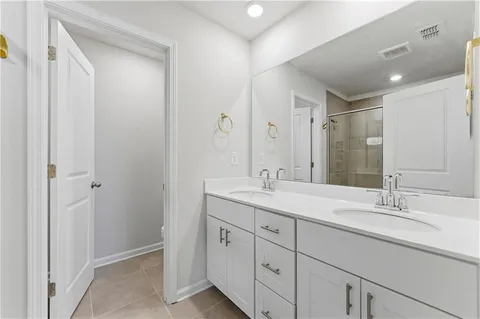 a bathroom with a double vanity sink mirror and