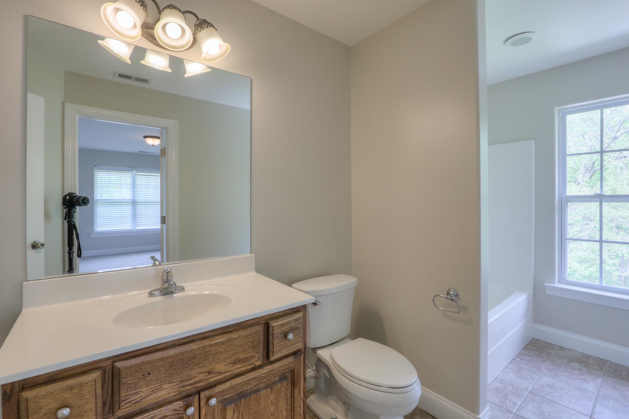 202 Ridgewater Way Mount Juliet, TN 37122 - Photo 21 of 30 a bathroom with a sink a toilet a mirror and a window