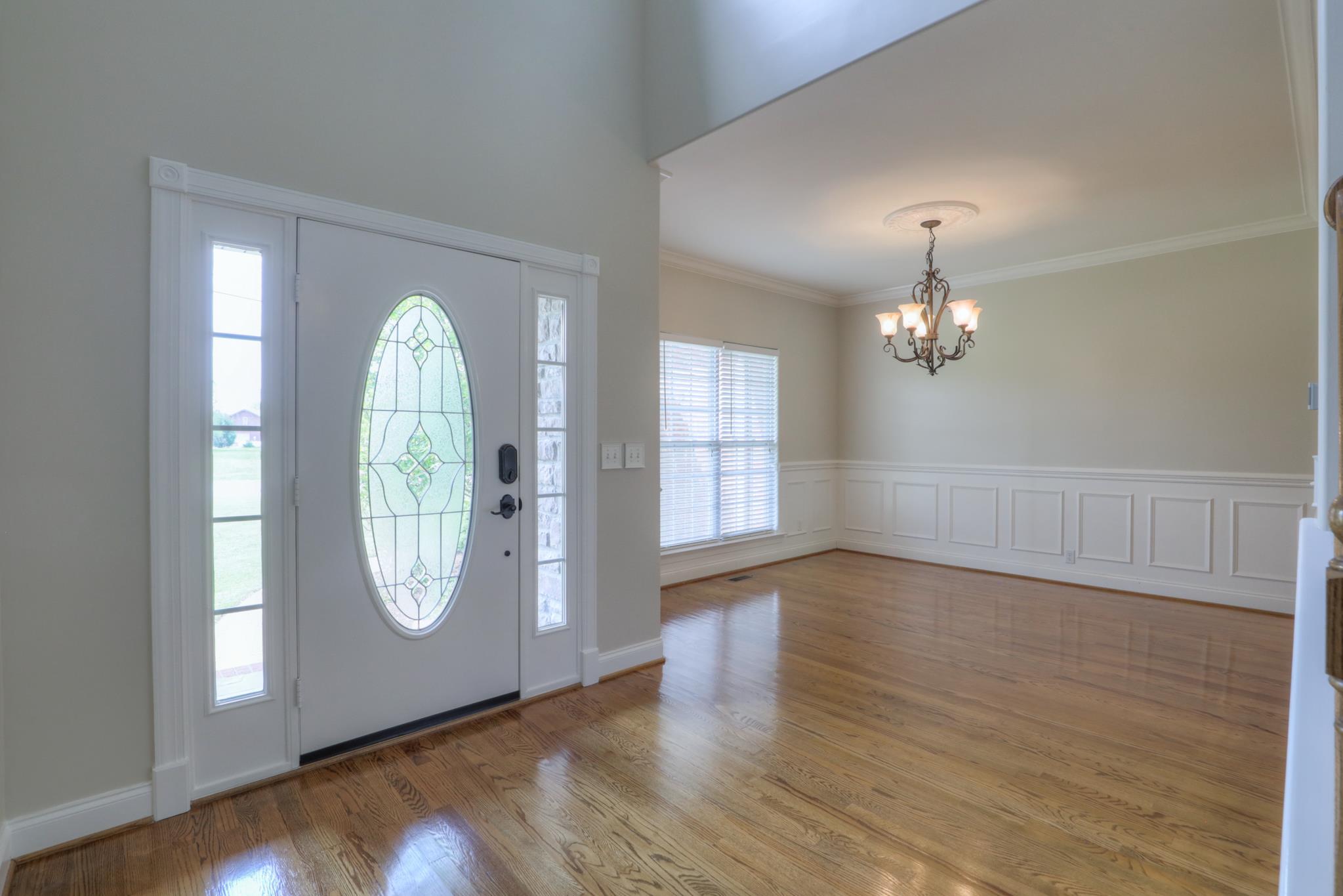 202 Ridgewater Way Mount Juliet, TN 37122 - Photo 8 of 30 an empty room with wooden floor mirror and windows