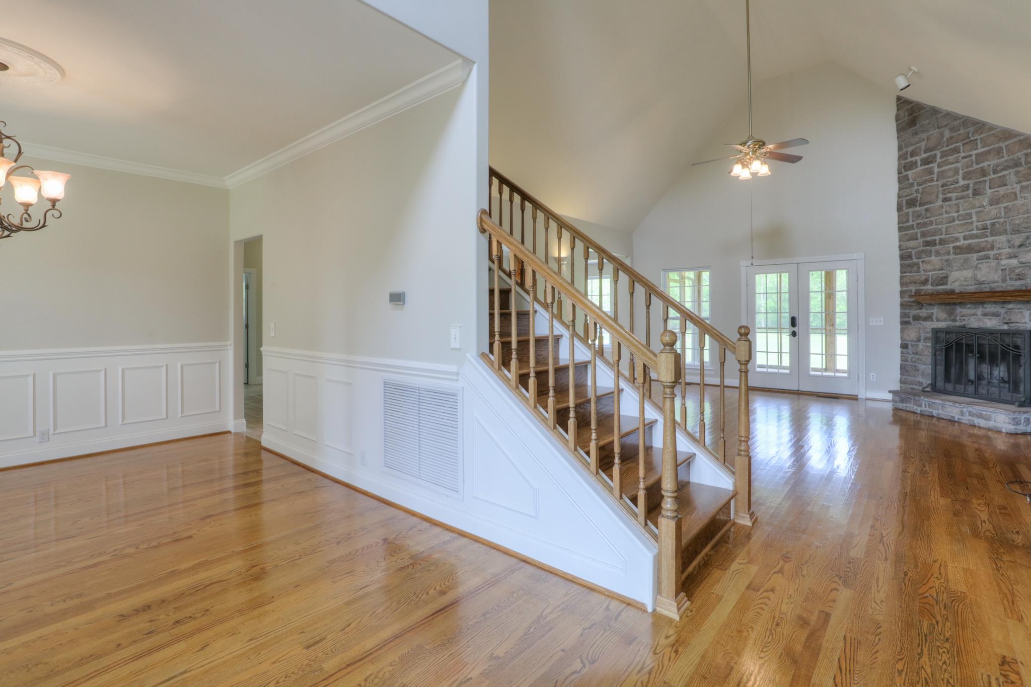 202 Ridgewater Way Mount Juliet, TN 37122 - Photo 9 of 30 a view of staircase with wooden floor and a fireplace