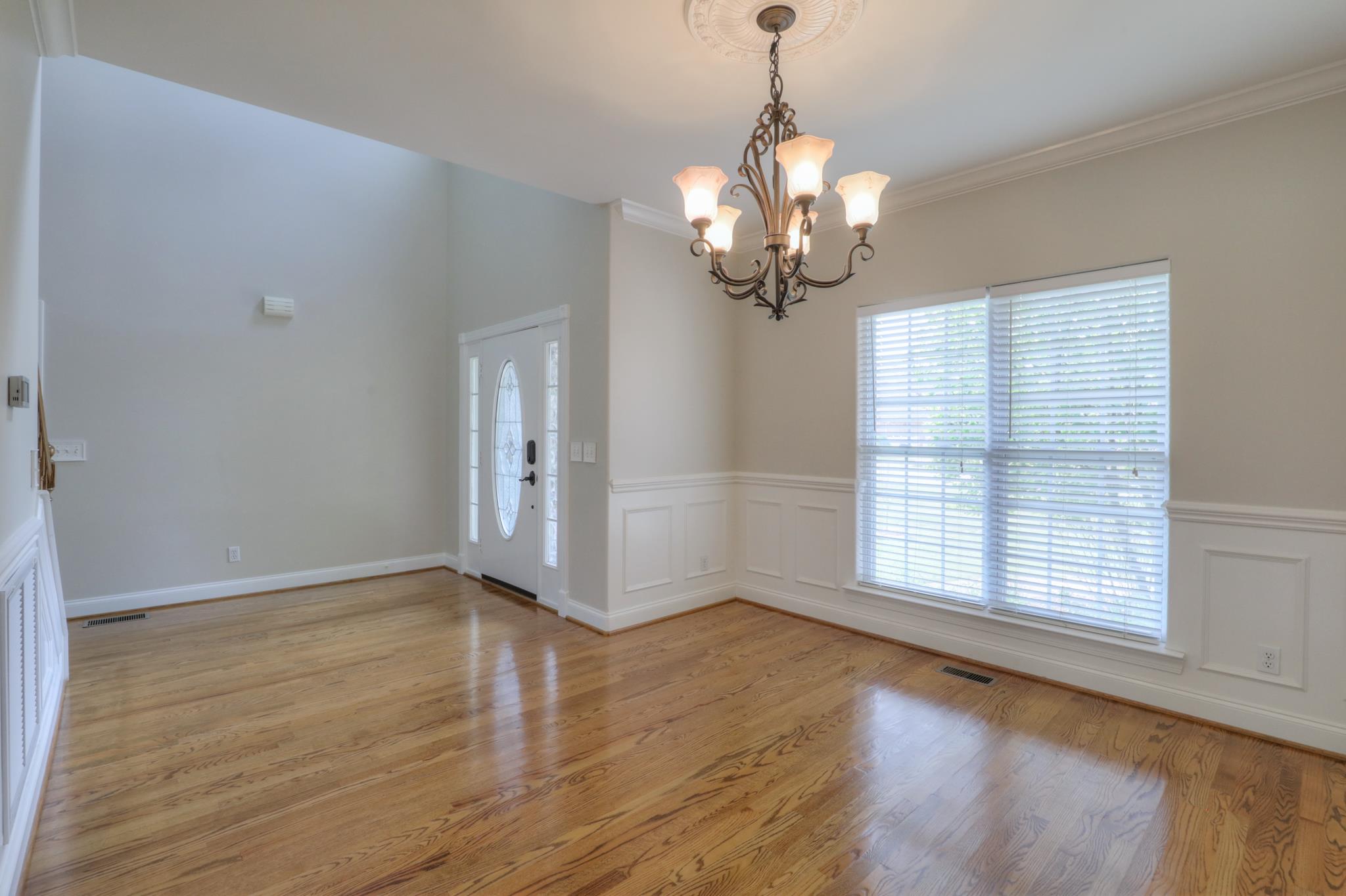 202 Ridgewater Way Mount Juliet, TN 37122 - Photo 10 of 30 an empty room with wooden floor chandelier and windows