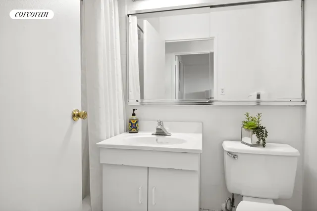 a bedroom with a bed and dresser