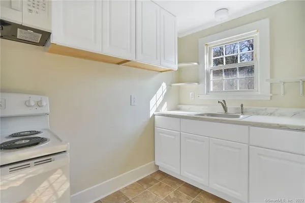a bathroom with a sink and a window