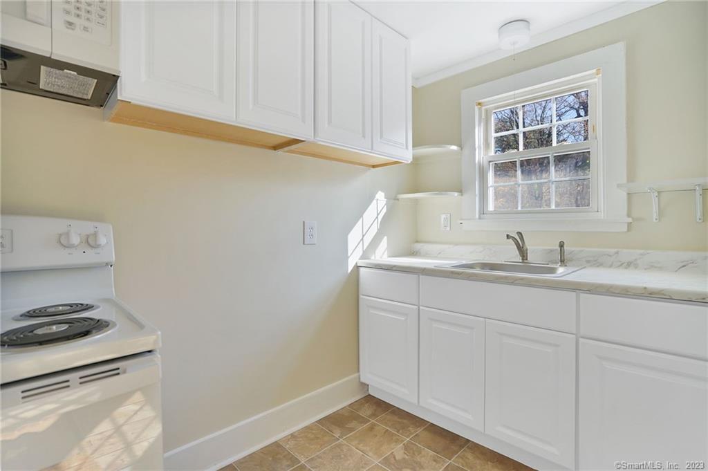 752 Main Street, Unit 5 Somers, CT 06071 - Photo 16 of 17 a bathroom with a sink and a window