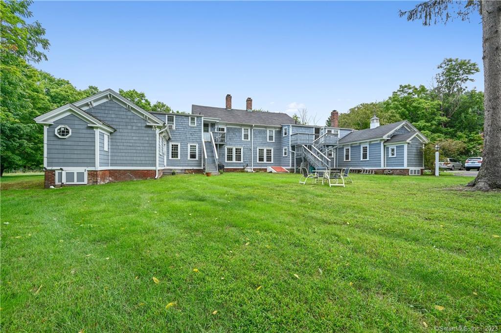 752 Main Street, Unit 5 Somers, CT 06071 - Photo 5 of 17 a view of a house with a yard and sitting area