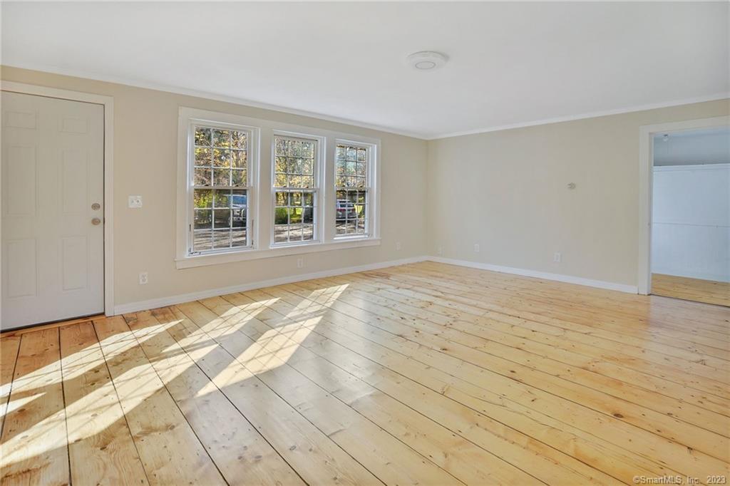 752 Main Street, Unit 5 Somers, CT 06071 - Photo 10 of 17 a view of an empty room with wooden floor and a window