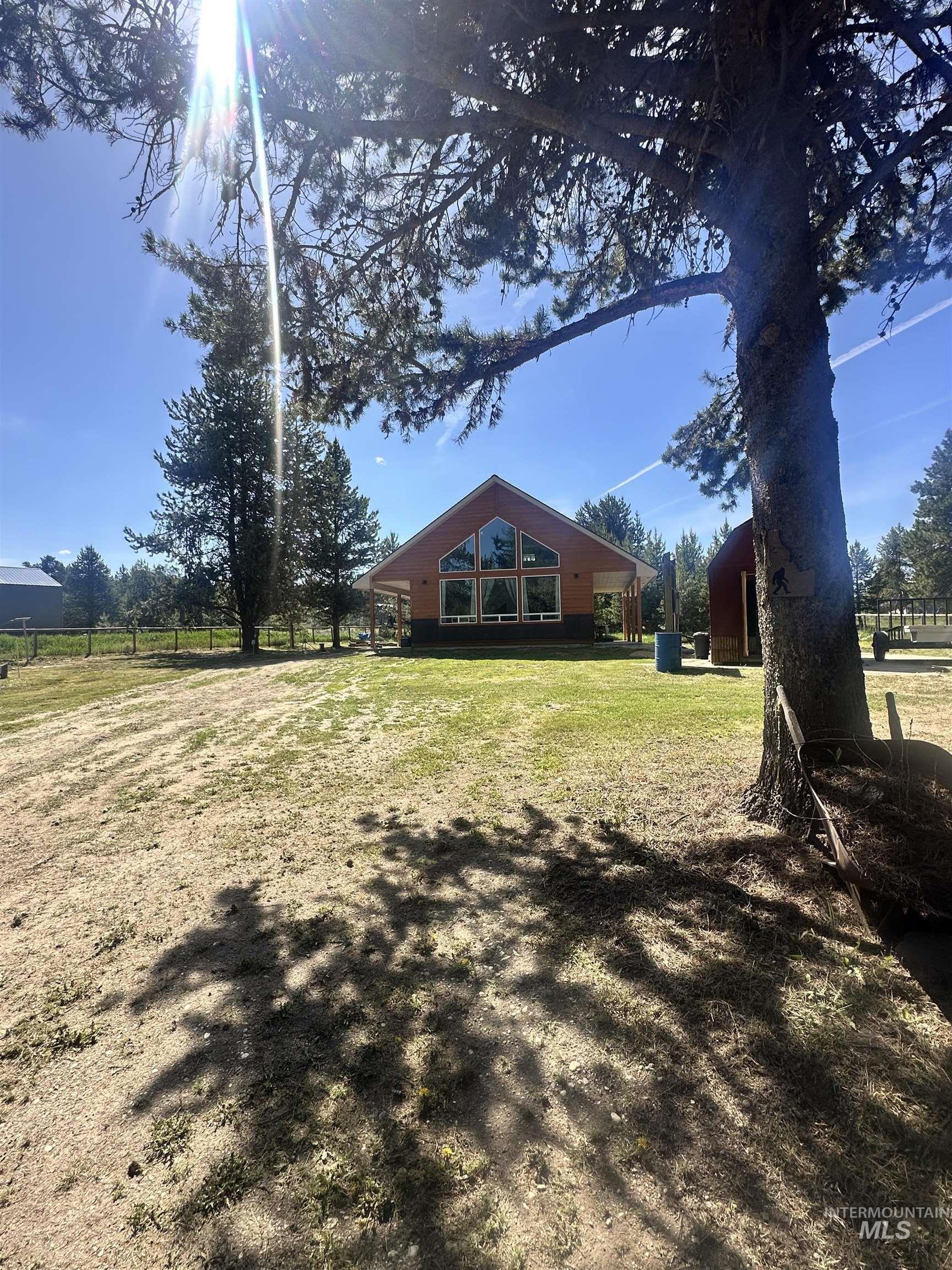 22 West Prospectors Drive Cascade, ID 83611 - Photo 28 of 29 Rustic-style dwelling with a gabled roof and a large window arrangement