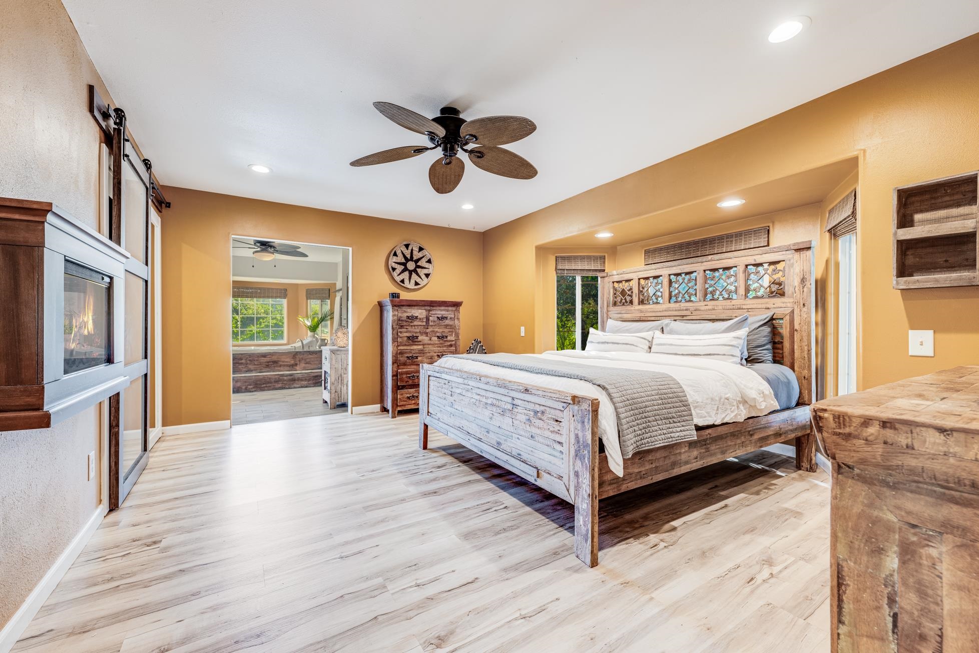 951 Kokomo Road Haiku, HI 96708 - Photo 16 of 50 a bedroom with a large bed a flat tv screen and dresser
