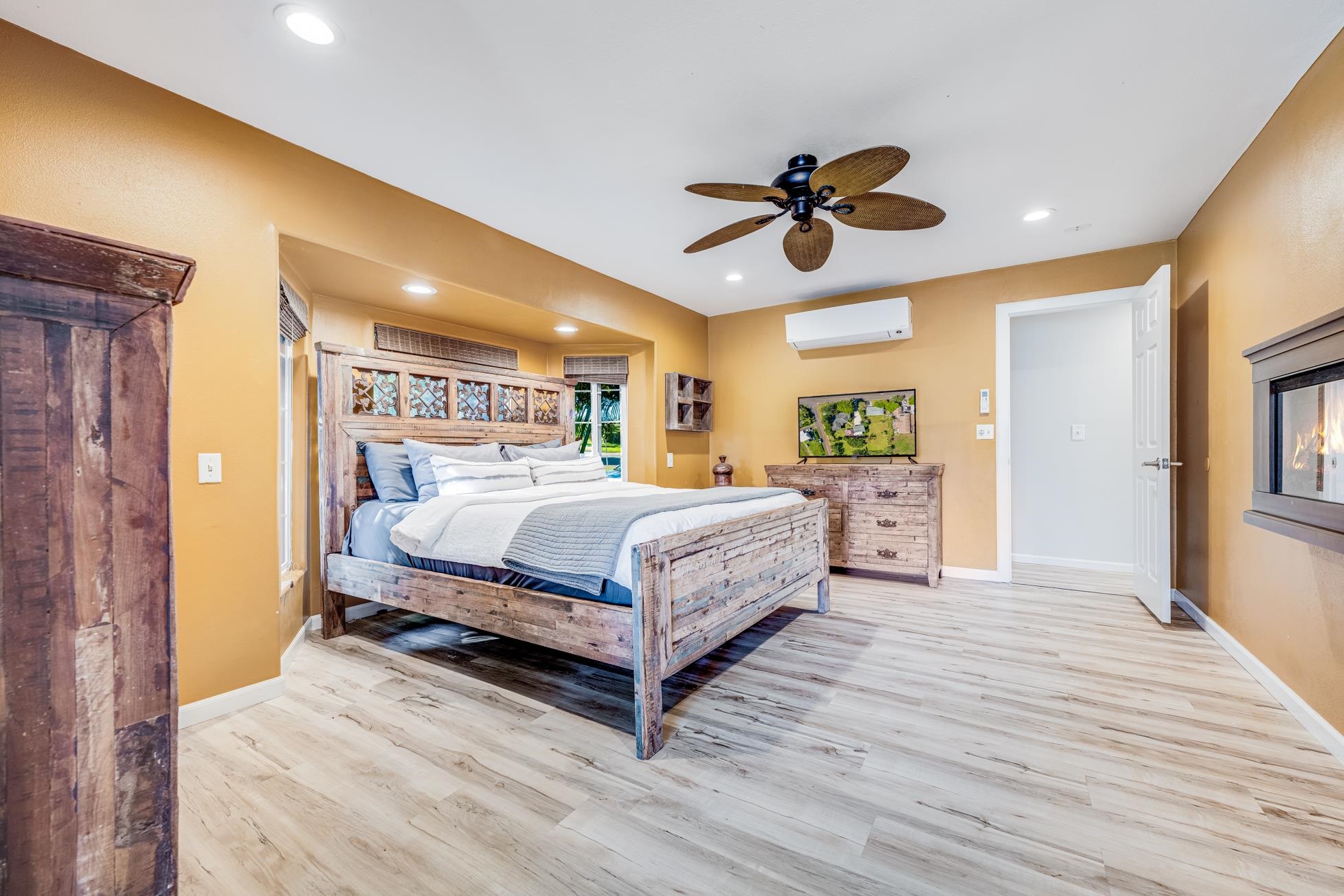 951 Kokomo Road Haiku, HI 96708 - Photo 18 of 50 a bedroom with a bed chandelier and a window