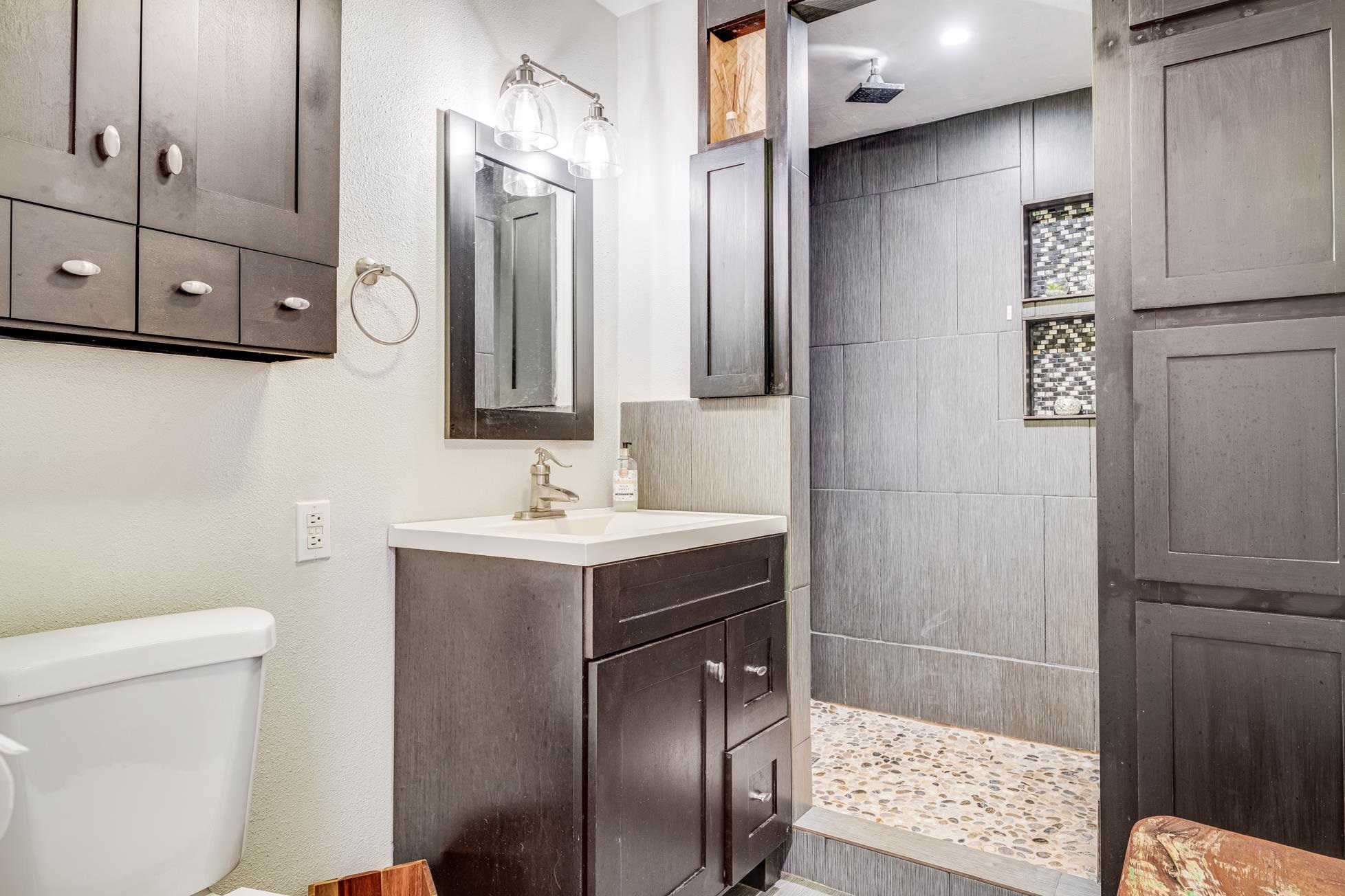 951 Kokomo Road Haiku, HI 96708 - Photo 28 of 50 a bathroom with a sink a toilet and shower