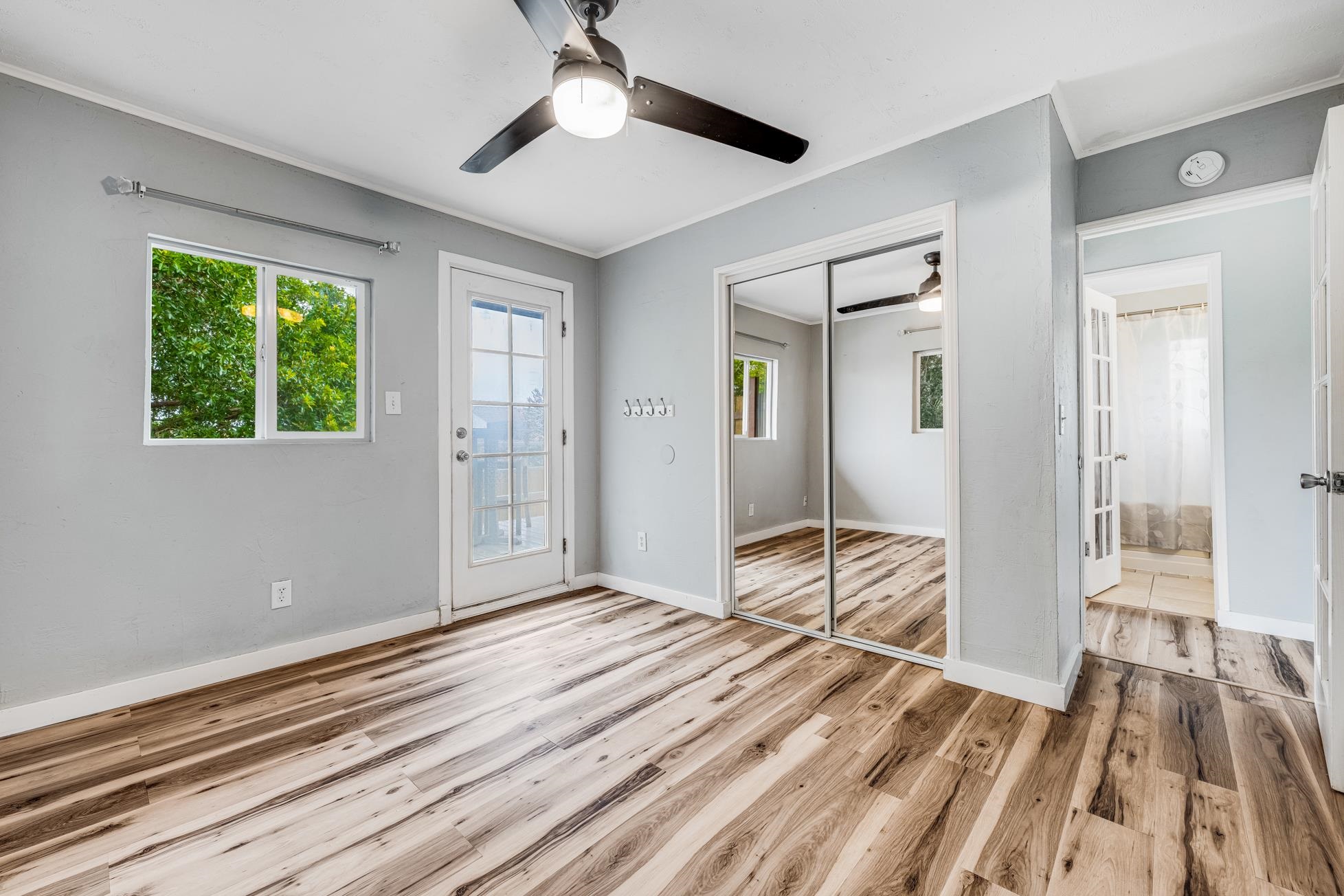 951 Kokomo Road Haiku, HI 96708 - Photo 40 of 50 a view of a livingroom with wooden floor and a ceiling fan