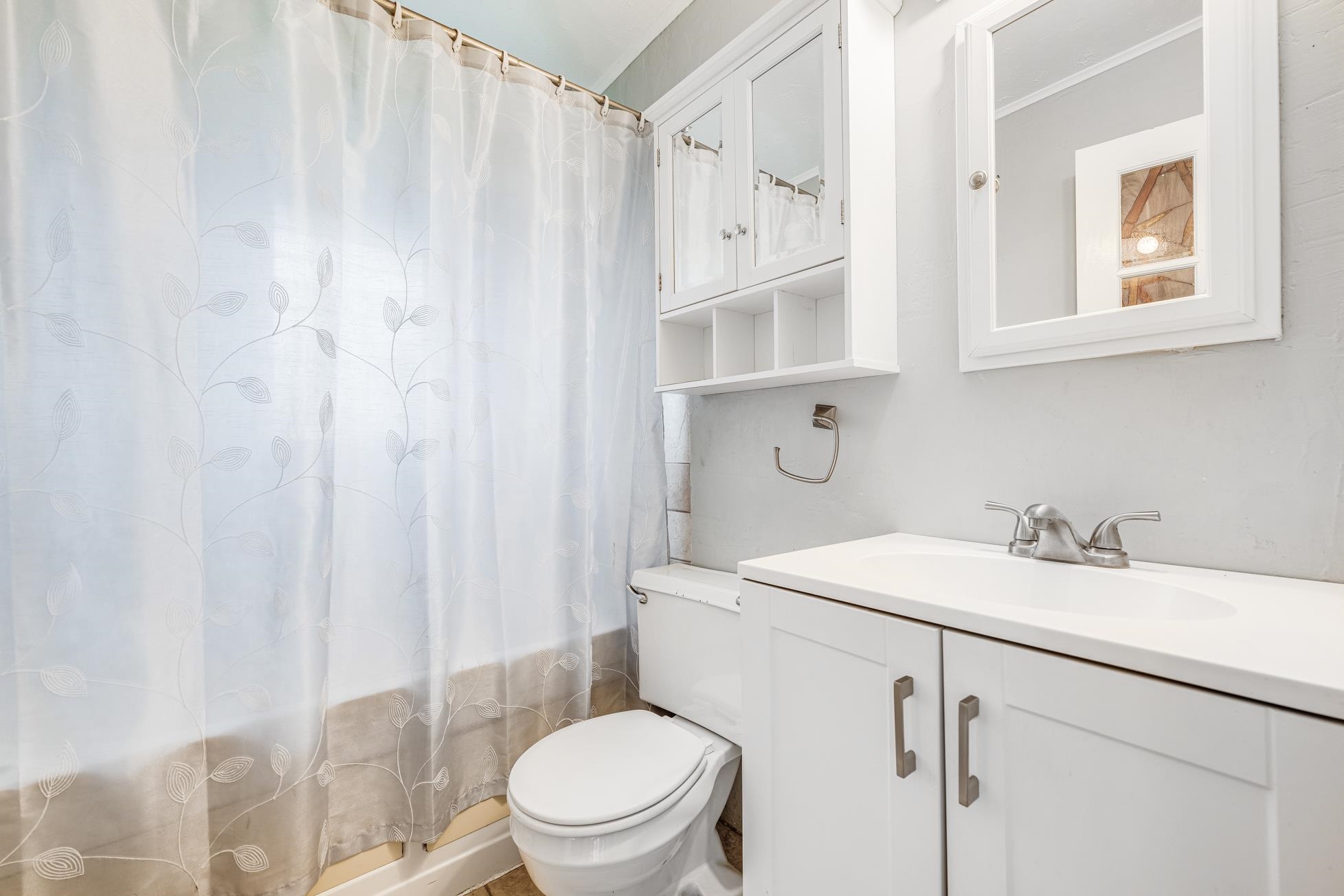 951 Kokomo Road Haiku, HI 96708 - Photo 42 of 50 a bathroom with a sink a toilet and shower curtain