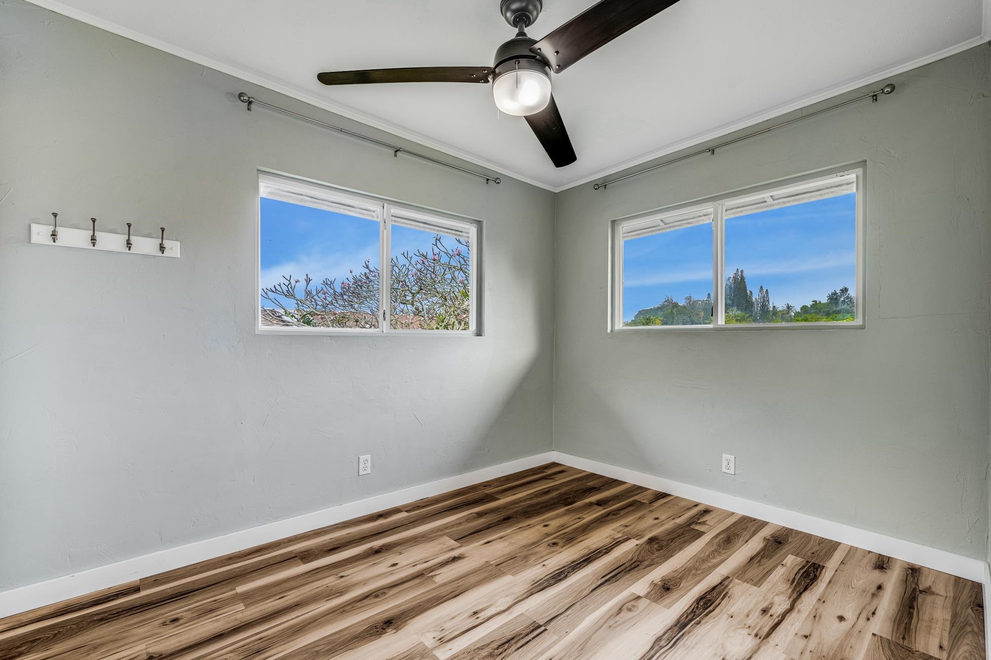 951 Kokomo Road Haiku, HI 96708 - Photo 43 of 50 a view of a room with wooden floor and chandelier