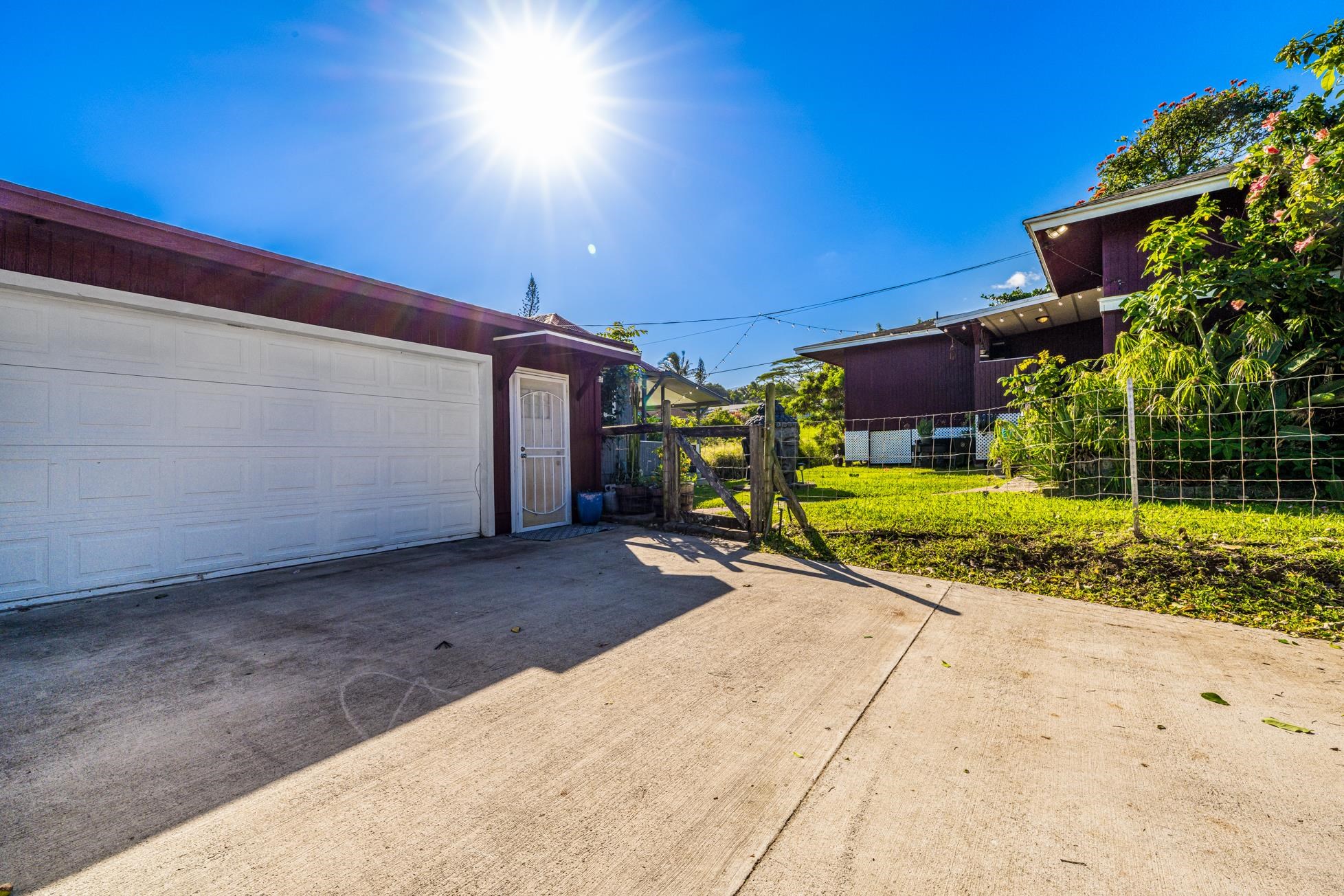 951 Kokomo Road Haiku, HI 96708 - Photo 44 of 50 a view of a backyard with brick wall and potted plants
