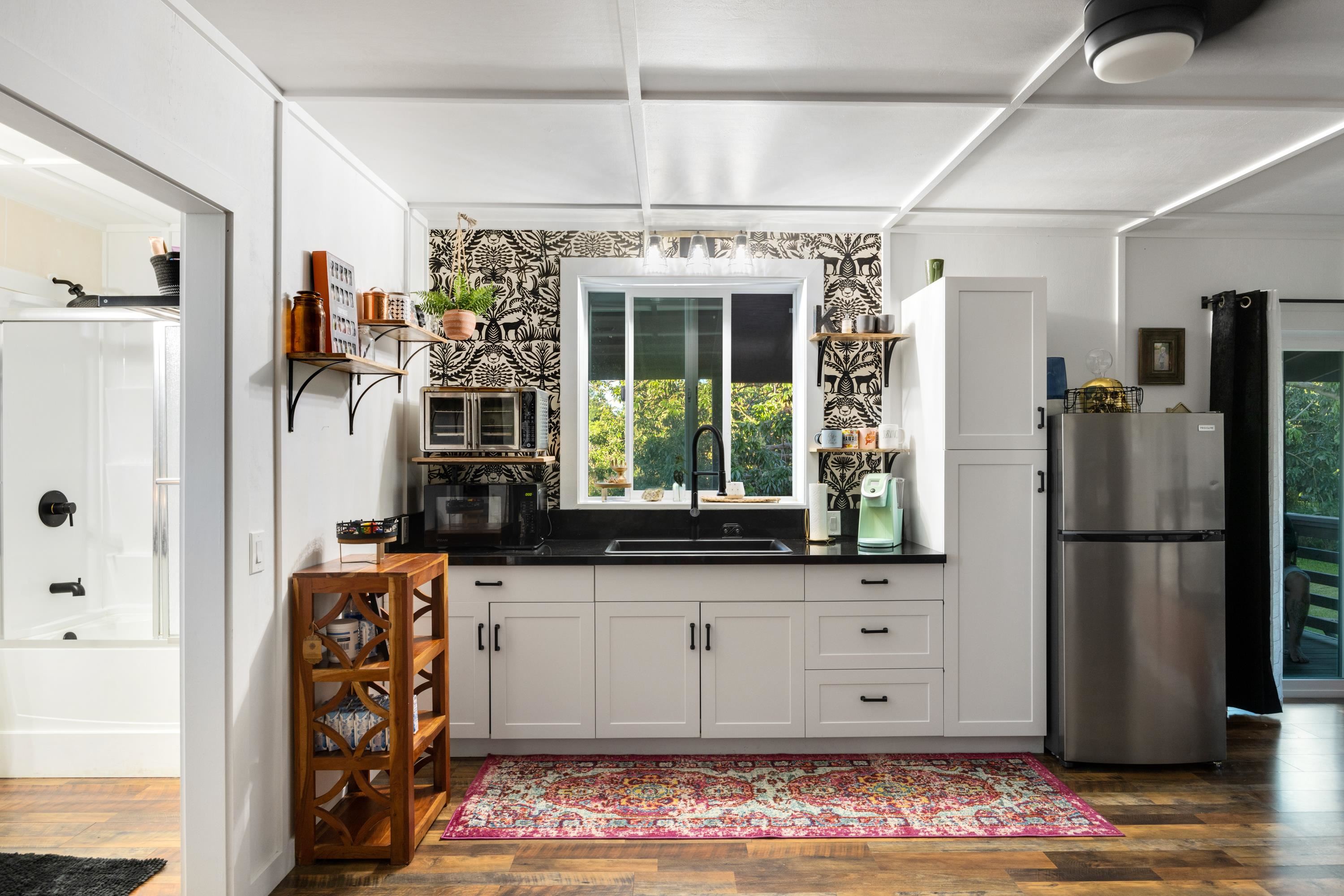 951 Kokomo Road Haiku, HI 96708 - Photo 46 of 50 a kitchen with stainless steel appliances granite countertop a refrigerator and a stove