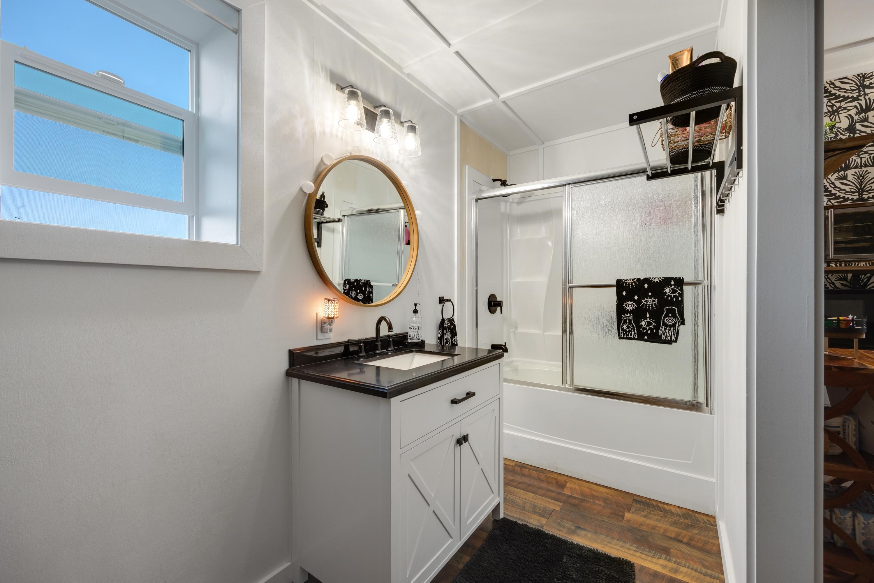 951 Kokomo Road Haiku, HI 96708 - Photo 48 of 50 a bathroom with a sink a mirror and vanity
