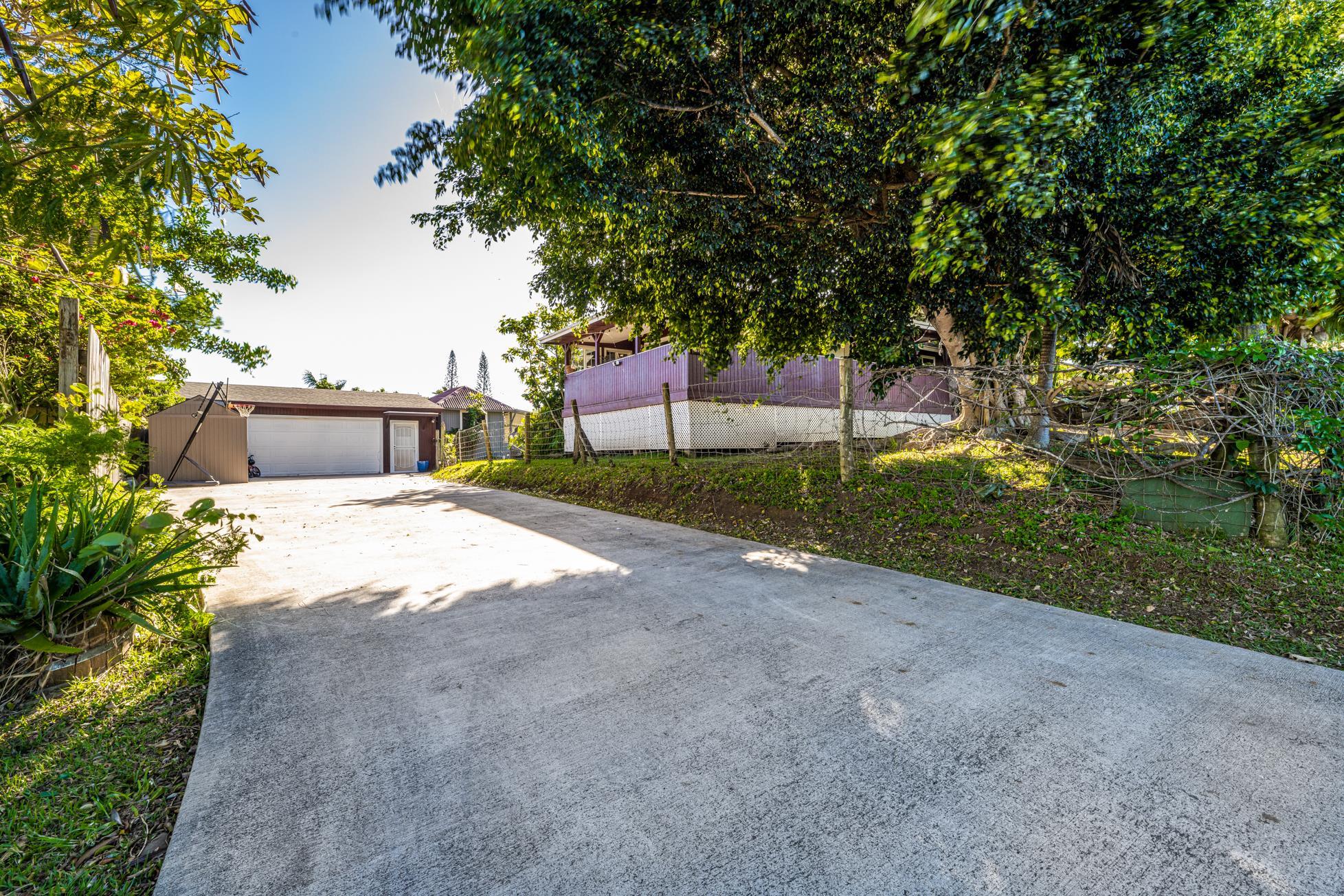 951 Kokomo Road Haiku, HI 96708 - Photo 49 of 50 a yellow house with trees in front of it