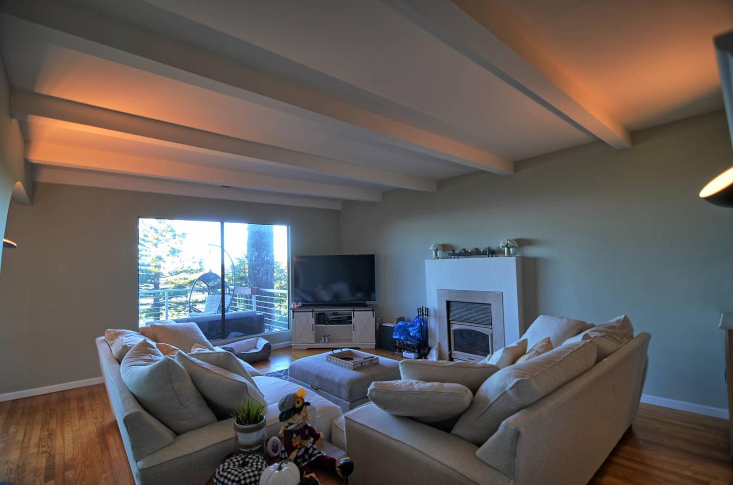 254 Swett Road Woodside, CA 94062 - Photo 6 of 26 a living room with furniture a fireplace and a flat screen tv