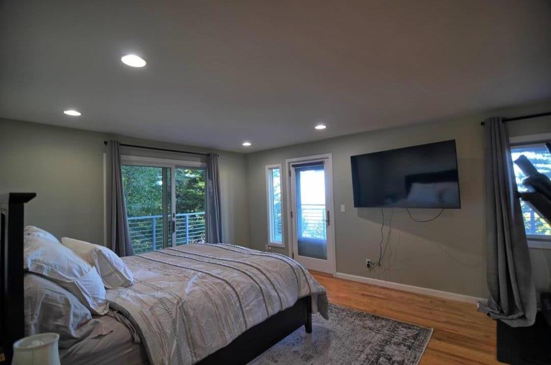 254 Swett Road Woodside, CA 94062 - Photo 10 of 26 a bedroom with a bed and a flat screen tv